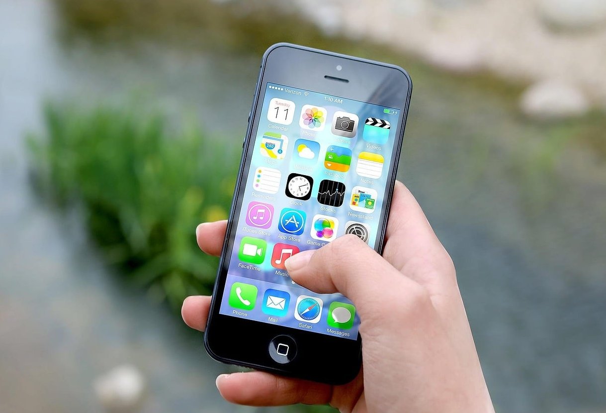 finger touching phone screen