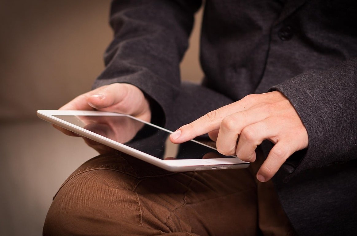 finger touching phone screen