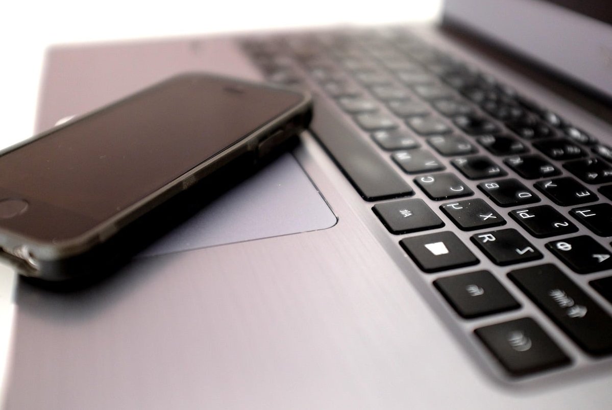 finger touching phone screen